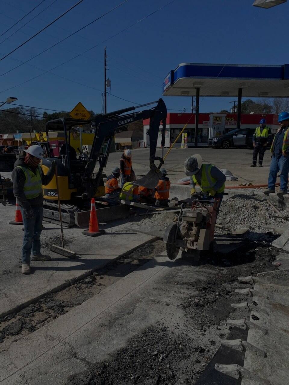 V Construction crew cutting and finishing concrete on a commercial job site in San Antonio